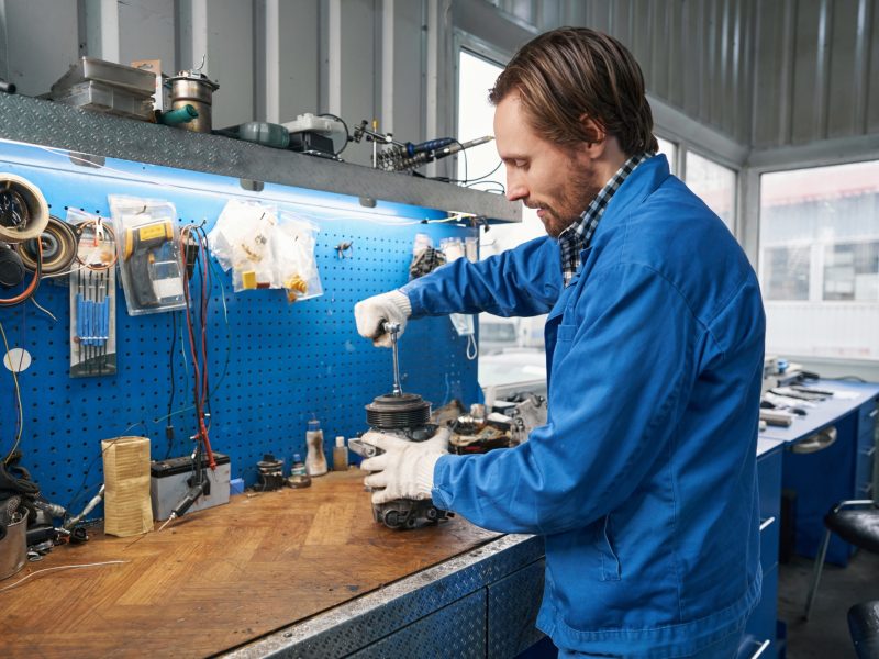 Male replaces a car air conditioner compressor bearing